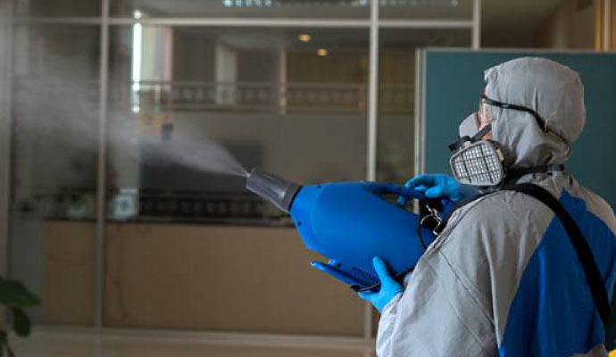 Person is disinfecting an indoor area using equipment