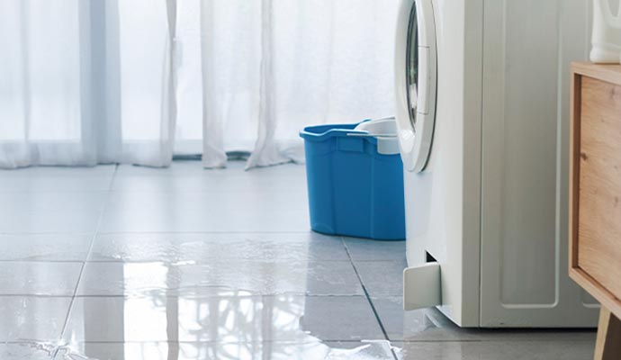 A damaged washing machine leaking water