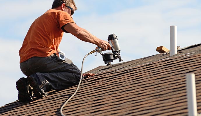 Professional worker replacing roof