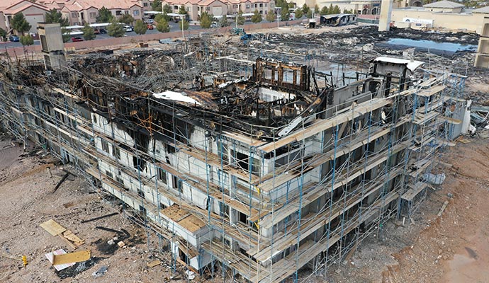 Aerial view of a multi-story building severely damaged by fire