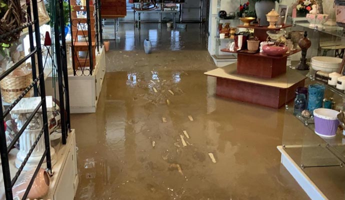 Indoor view of a store with water covering the floor indicating flooding