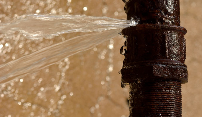 A leaking pipe with water flowing out